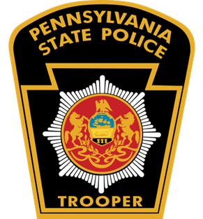 A badge of the Pennsylvania State Police featuring a central emblem with two lions and the word 